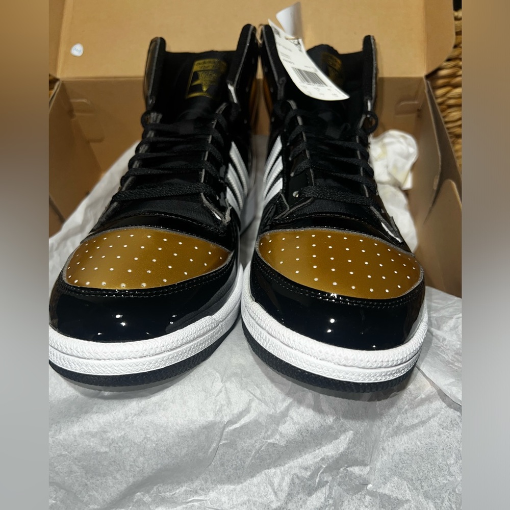 Men’s Adidas top ten originals. Black/Gold patent leather. Never worn. Size 13